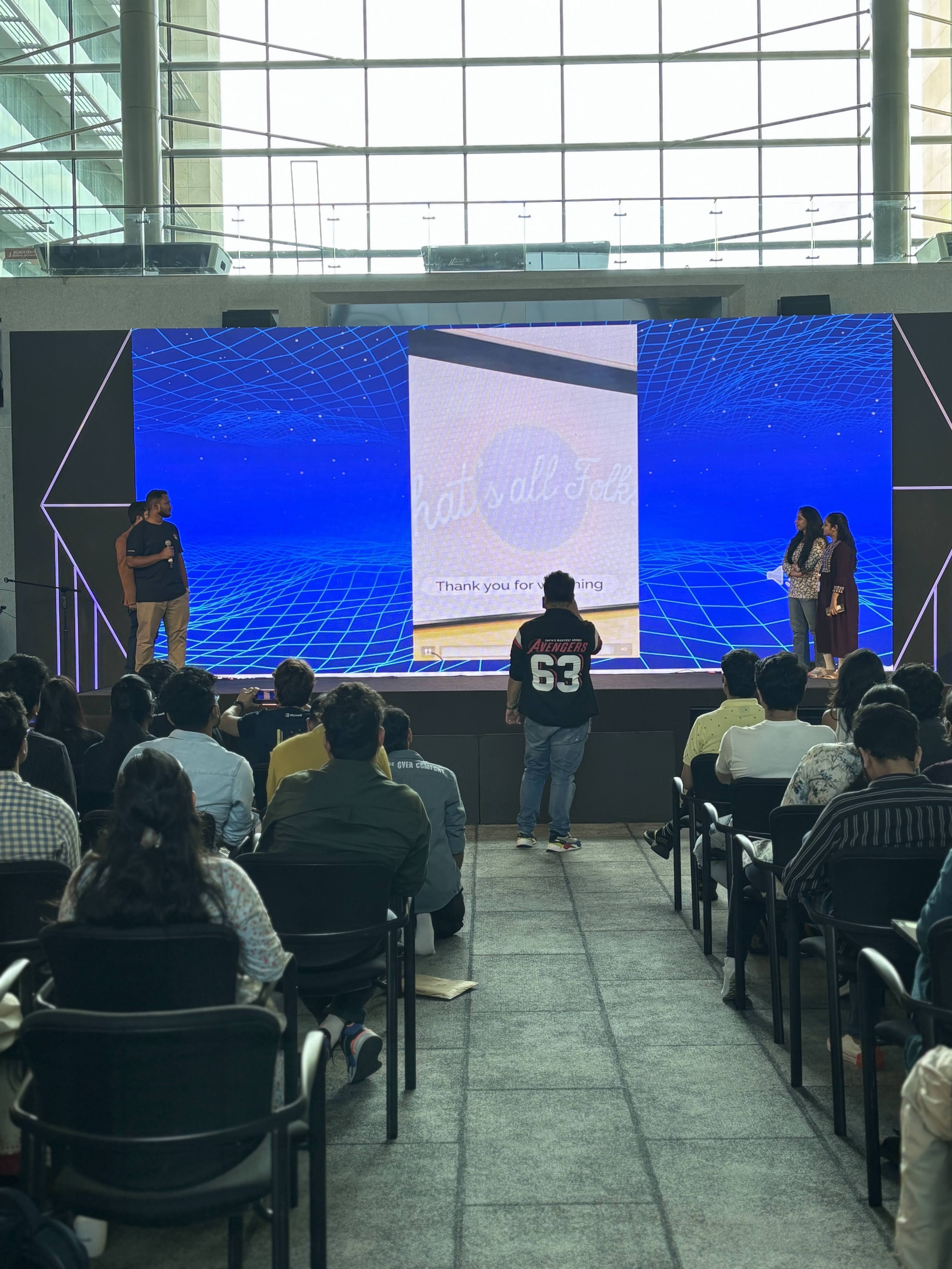 Tejj closing keynote, large LED grid screen, corporate atrium